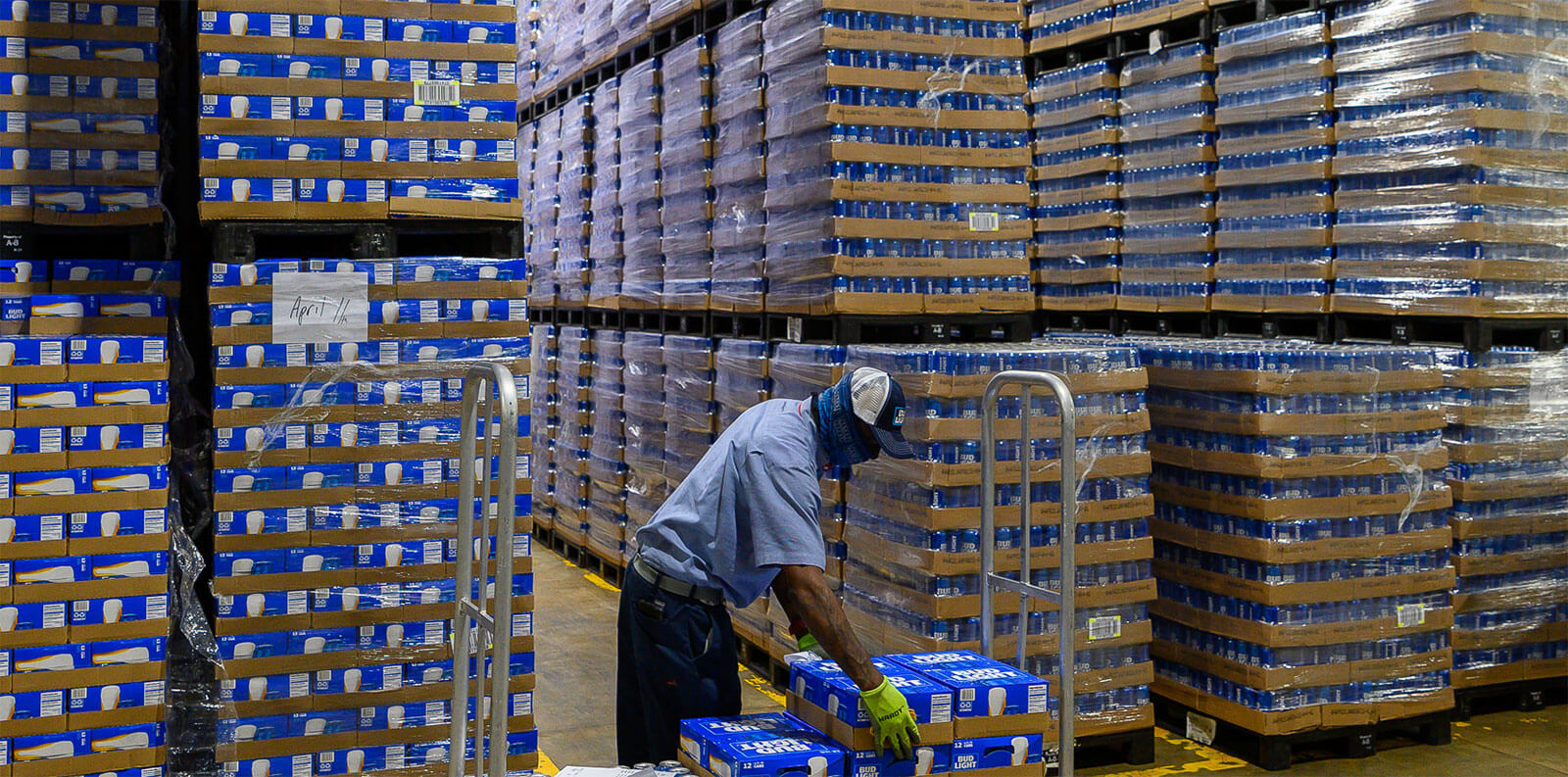 Employee placing cases onto cart